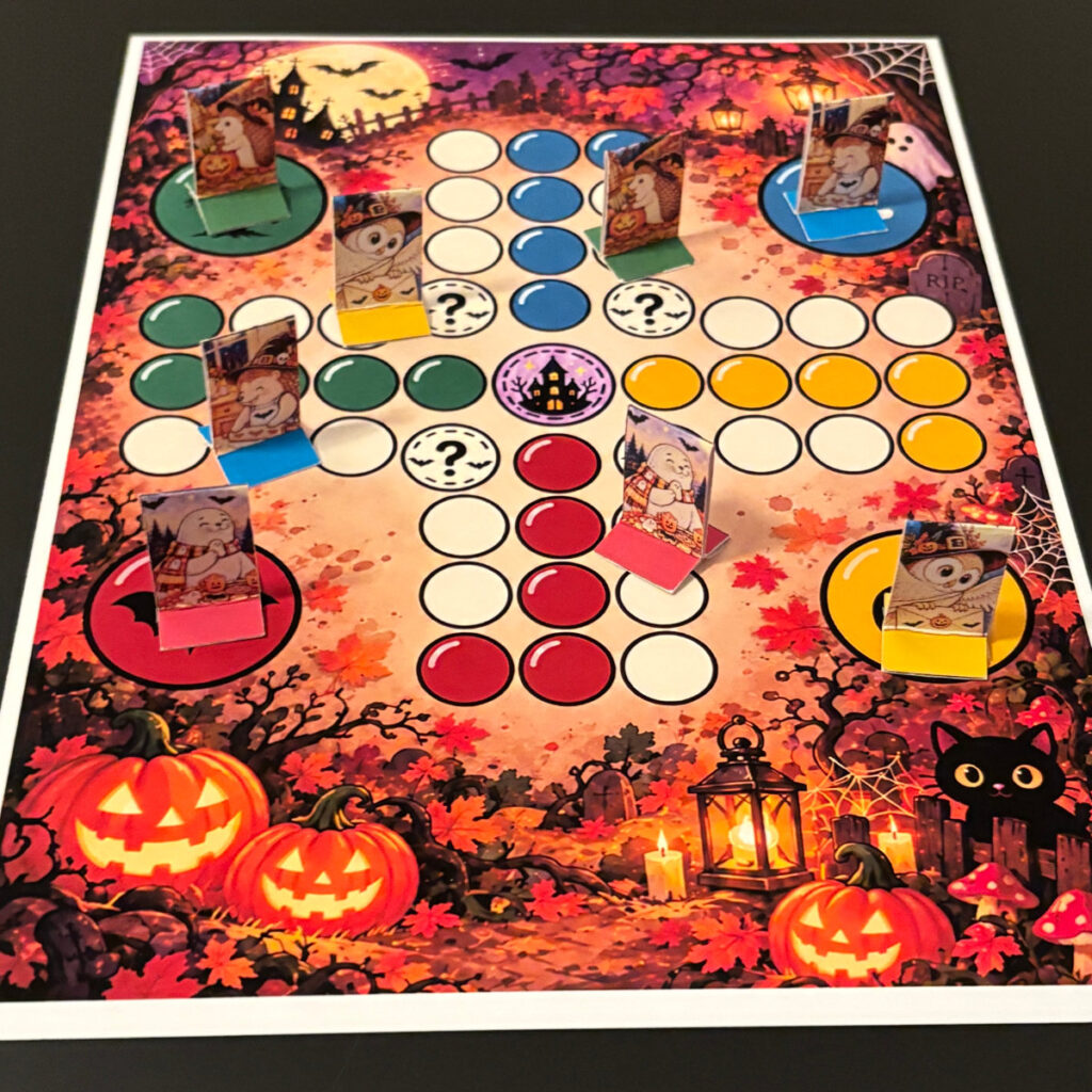 Fia med Bus Halloween, utskrivet brädspel med färgglad spelplan och stående papperspjäser med söta Halloweenfigurer.