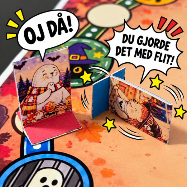 Två söta Halloweenpjäser från BOPUDO på en färgglad spelplan. Den ena säger ”OJ DÅ!” medan den andra välter och protesterar ”DU GJORDE DET MED FLIT!” i en humoristisk seriebild.